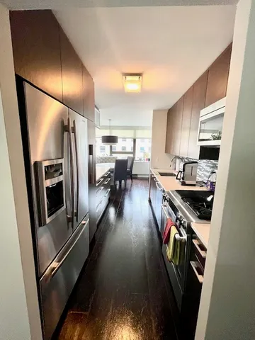 a kitchen with stainless steel appliances granite countertop a refrigerator stove and sink