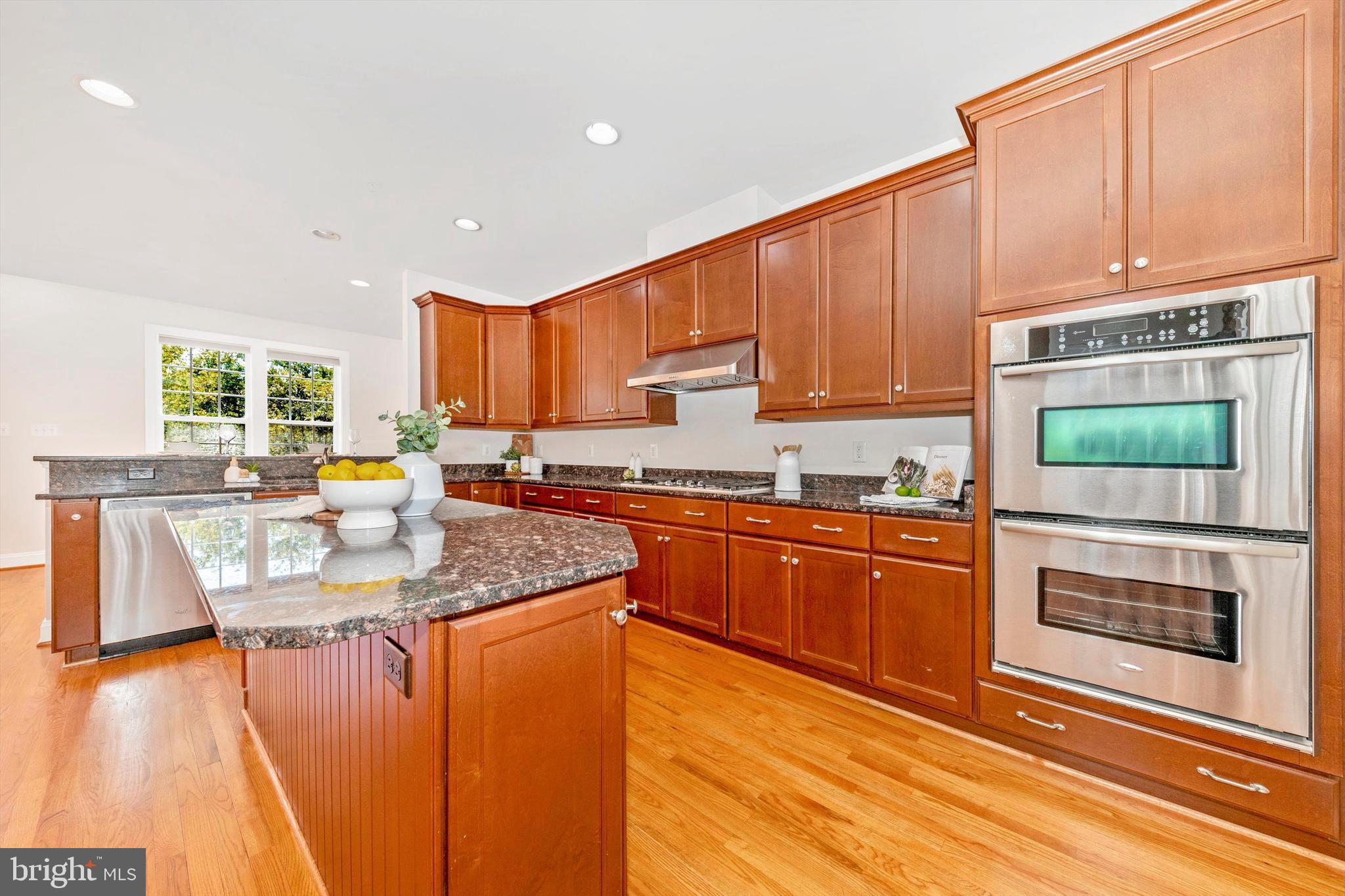 9655 Bothwell Lane Frederick, MD 21704 - Photo 18 of 58 a kitchen with stainless steel appliances granite countertop a stove a sink and a microwave