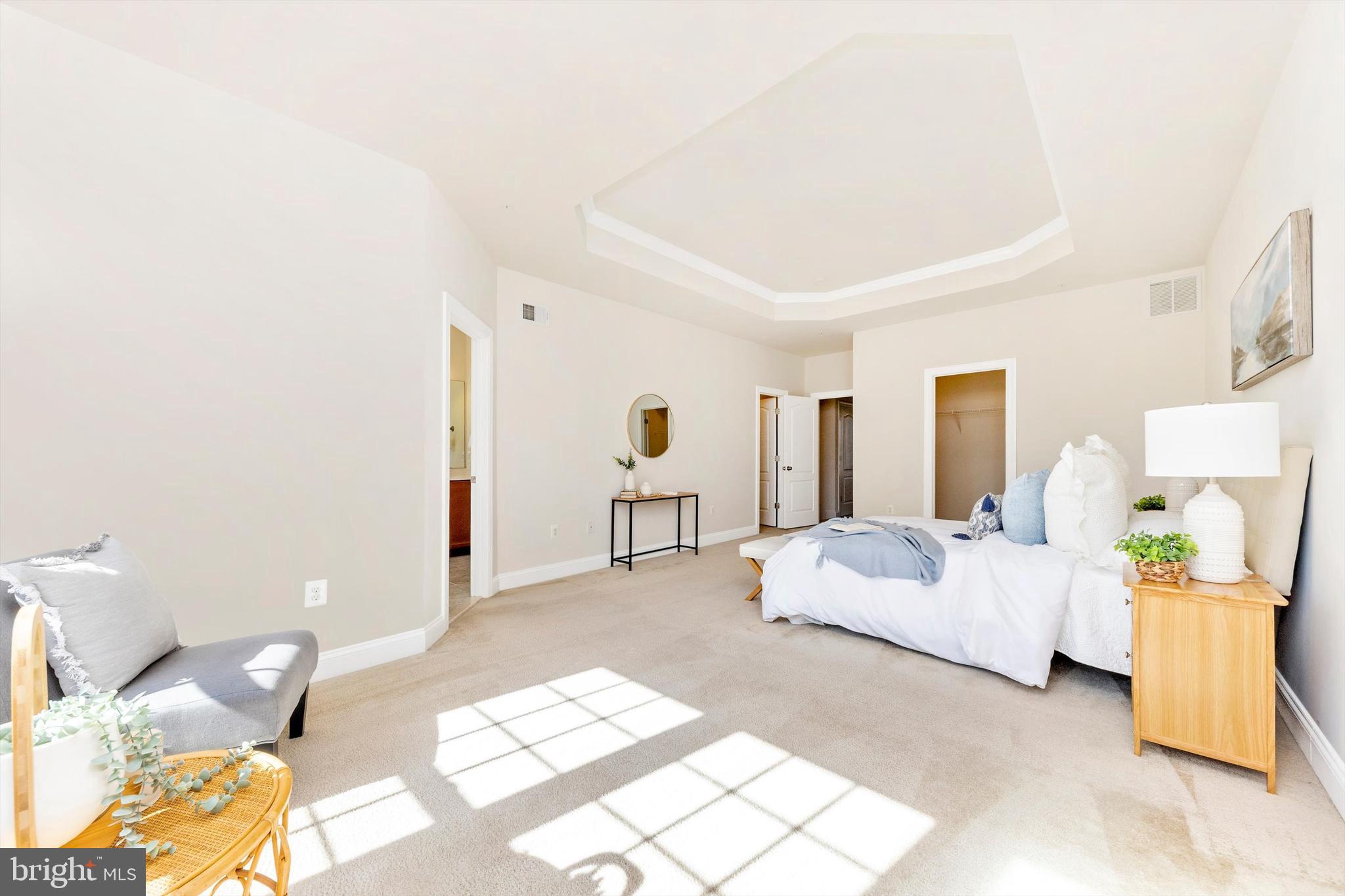 9655 Bothwell Lane Frederick, MD 21704 - Photo 30 of 58 a spacious bedroom with a bed and a couch