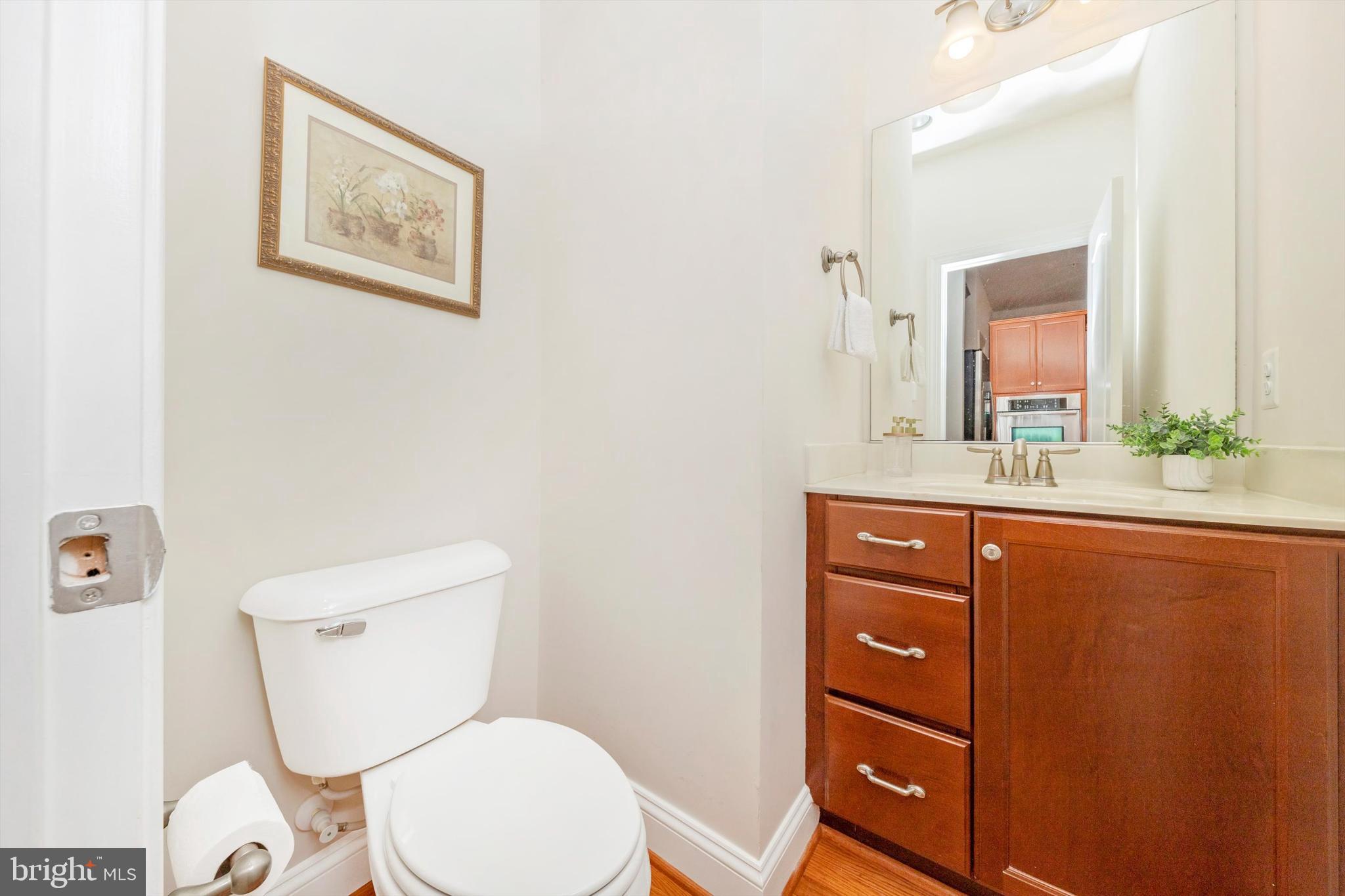 9655 Bothwell Lane Frederick, MD 21704 - Photo 38 of 58 a bathroom with a toilet a sink and mirror