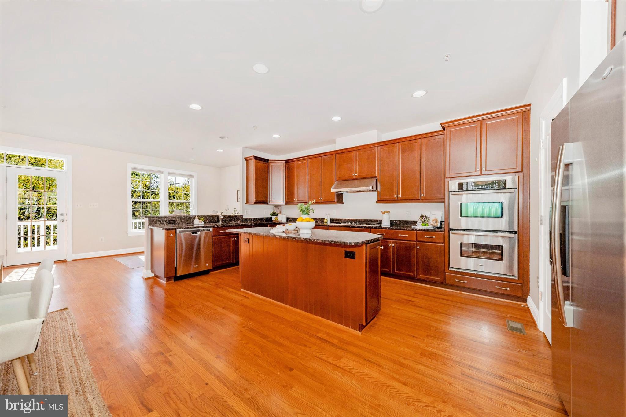 9655 Bothwell Lane Frederick, MD 21704 - Photo 4 of 58 a kitchen with stainless steel appliances wooden floors and refrigerator
