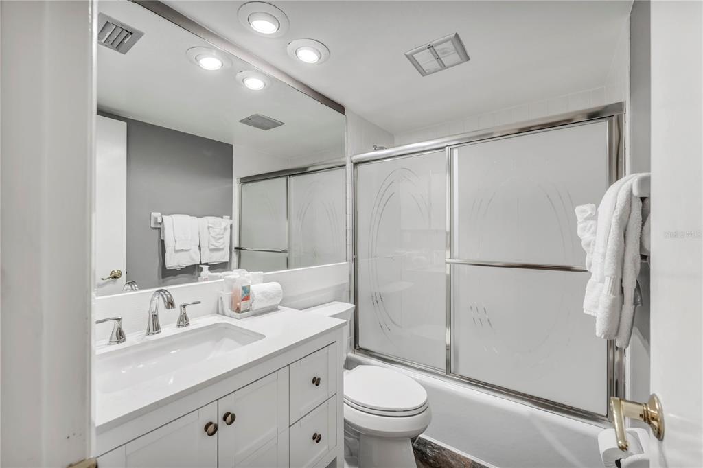 915 Beach Road, Unit 216 Sarasota, FL 34242 - Photo 16 of 30 a bathroom with a sink toilet double vanity and shower