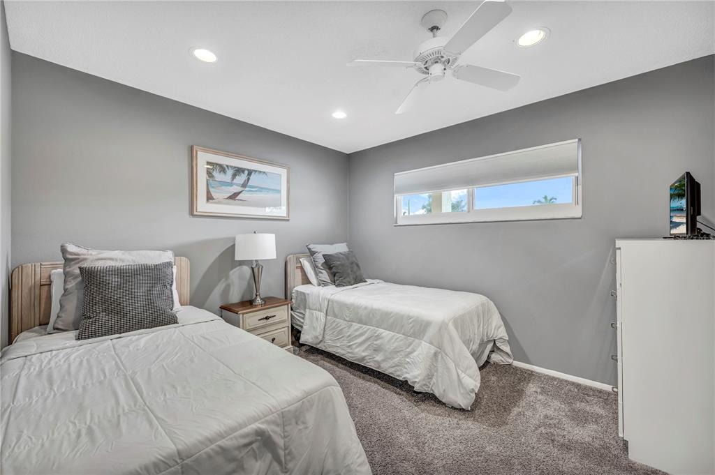 915 Beach Road, Unit 216 Sarasota, FL 34242 - Photo 17 of 30 a bedroom with two beds and a painting on the wall