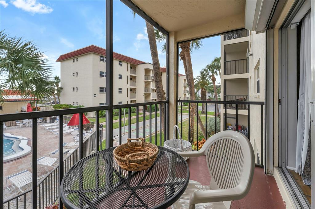 915 Beach Road, Unit 216 Sarasota, FL 34242 - Photo 18 of 30 a view of a balcony with chair and glass door