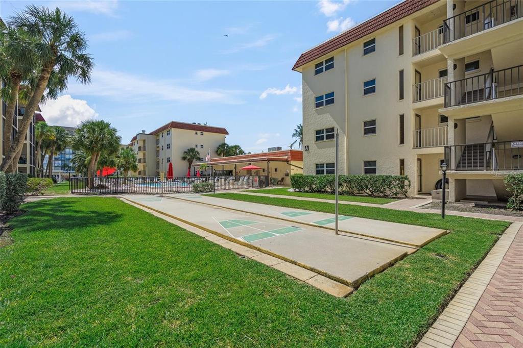 915 Beach Road, Unit 216 Sarasota, FL 34242 - Photo 28 of 30 a view of a big building with a big yard and potted plants