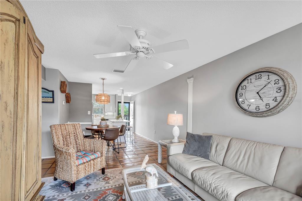 915 Beach Road, Unit 216 Sarasota, FL 34242 - Photo 6 of 30 a living room with furniture a clock on wall and a window