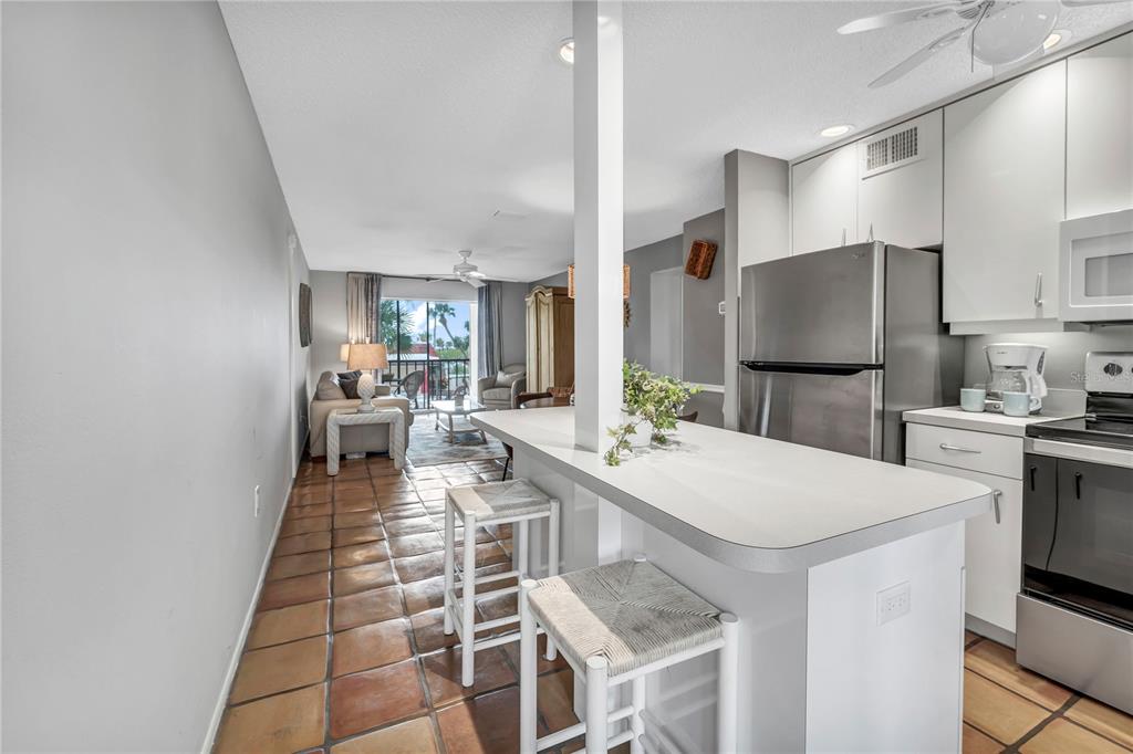 915 Beach Road, Unit 216 Sarasota, FL 34242 - Photo 8 of 30 a large kitchen with a table and chairs