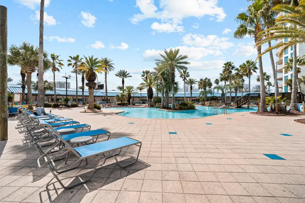 a multi story building with trees in front of it