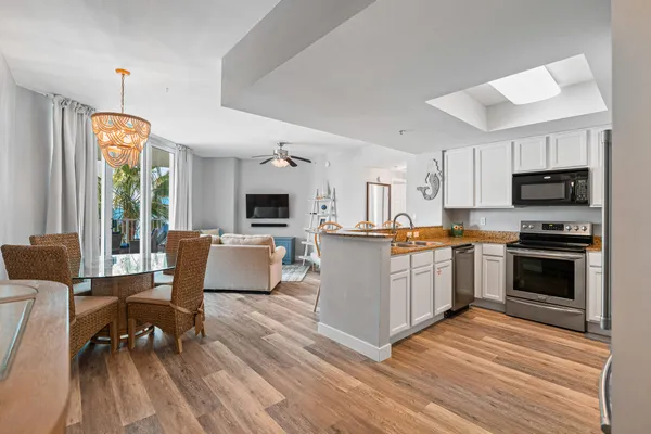 a kitchen with a sink stove and microwave