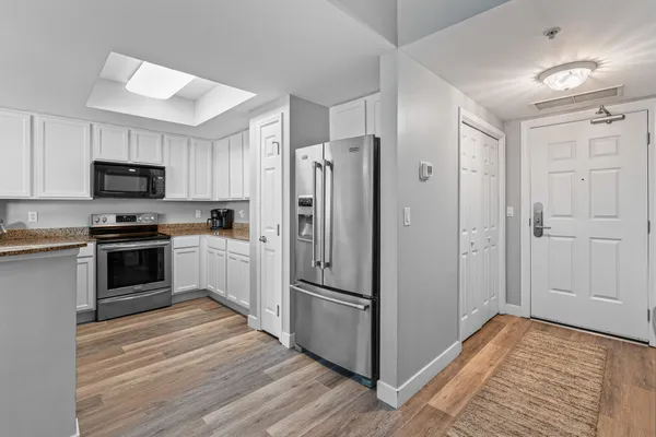 a kitchen with granite countertop a sink and cabinets