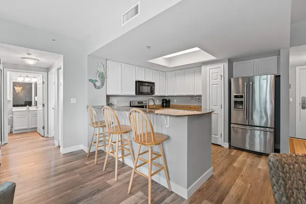 a living room with furniture a flat screen tv and a large window