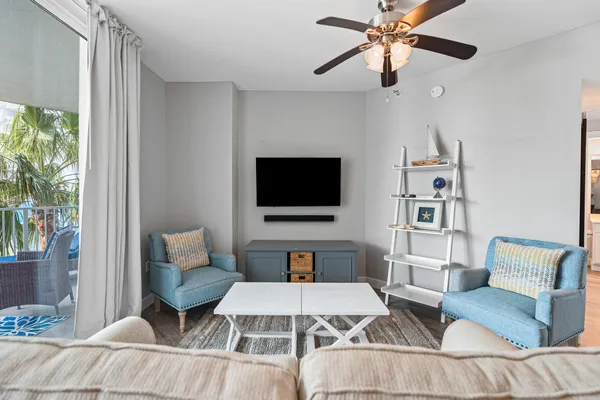 a living room with furniture a rug and a window