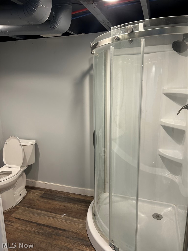 15317 Rockside Road Maple Heights, OH 44137 - Photo 12 of 14 Bathroom with hardwood / wood-style flooring, a shower with shower door, and toilet