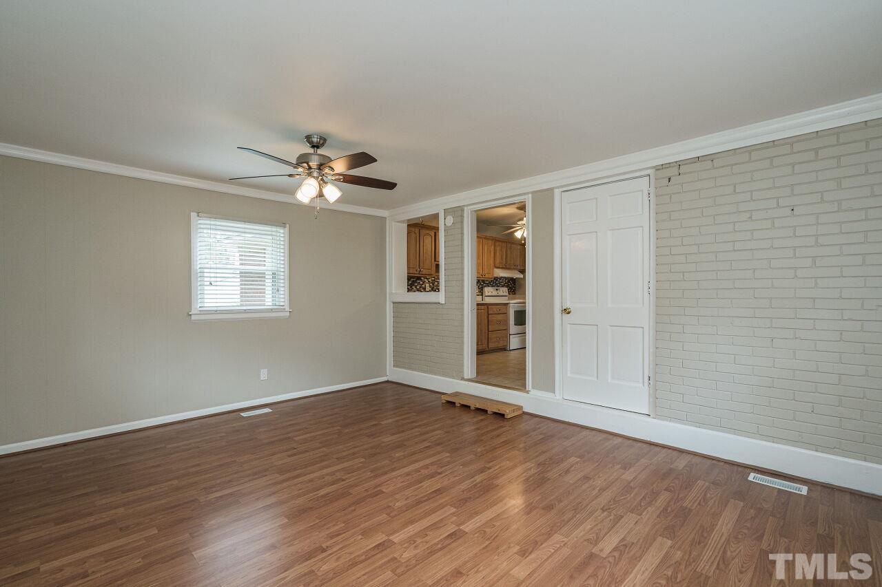 913 Culpepper Lane Raleigh, NC 27610 - Photo 14 of 23 wooden floor in an empty room with a window