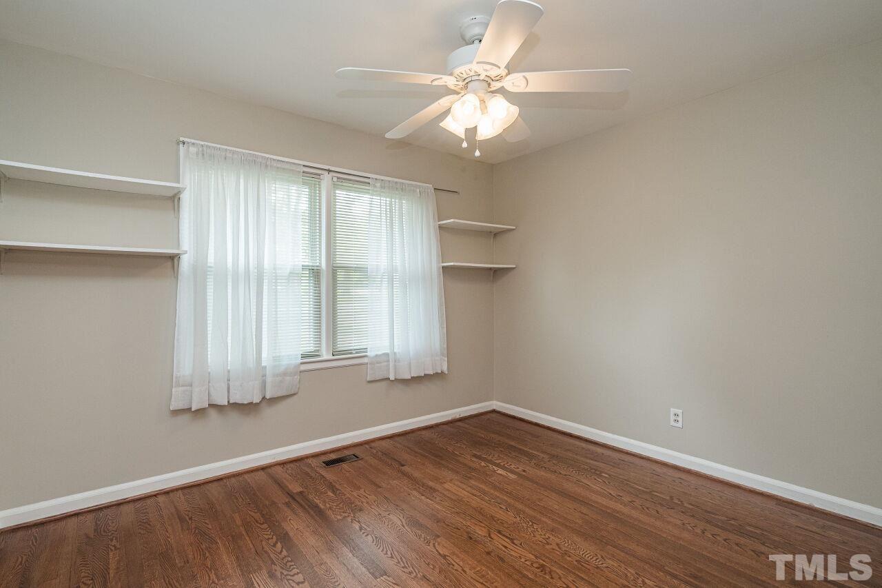913 Culpepper Lane Raleigh, NC 27610 - Photo 15 of 23 an empty room with wooden floor and windows