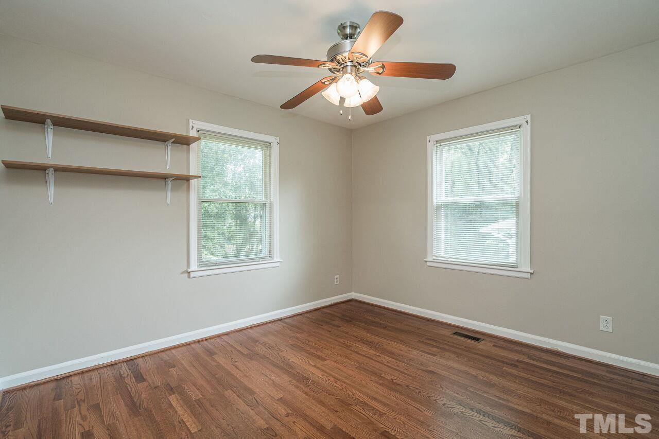 913 Culpepper Lane Raleigh, NC 27610 - Photo 16 of 23 a view of an empty room with wooden floor and a window