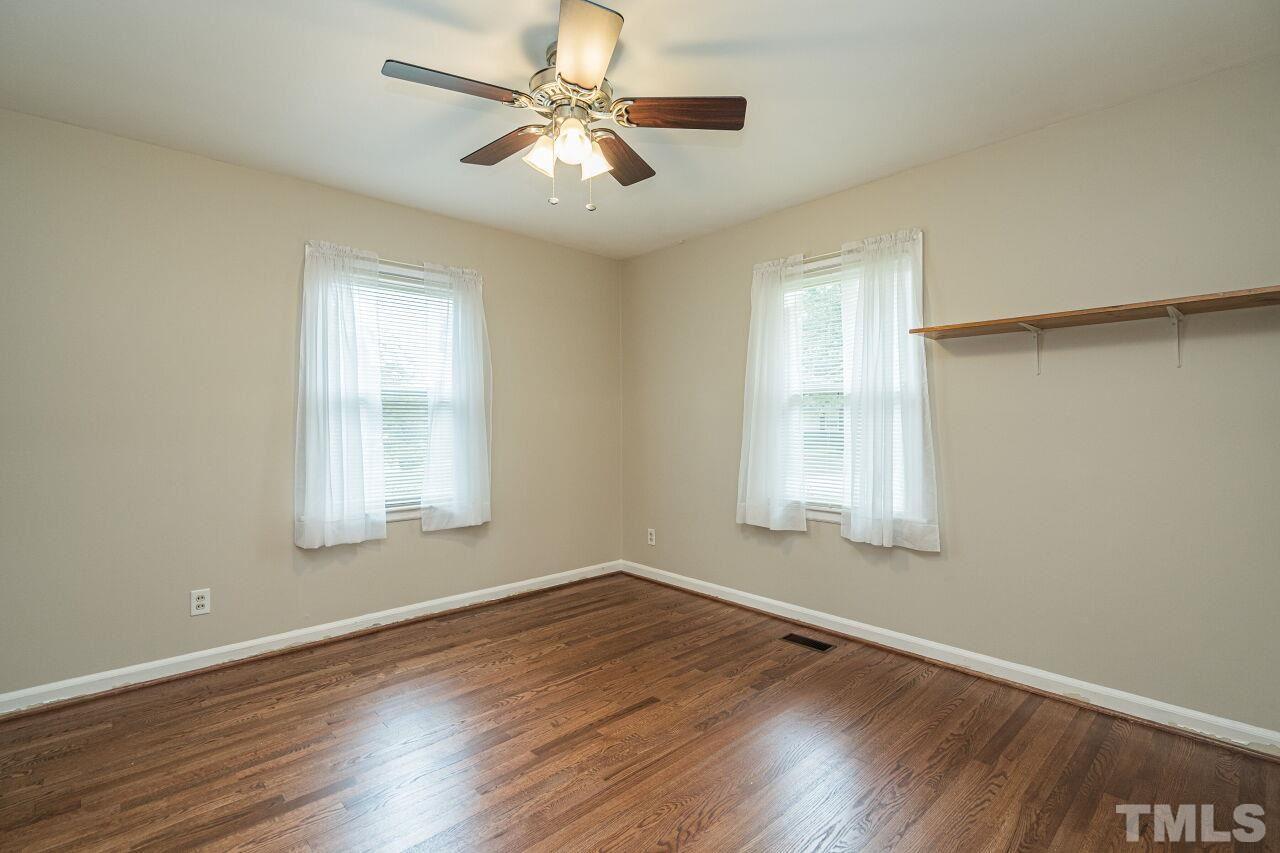 913 Culpepper Lane Raleigh, NC 27610 - Photo 17 of 23 wooden floor in an empty room with a window