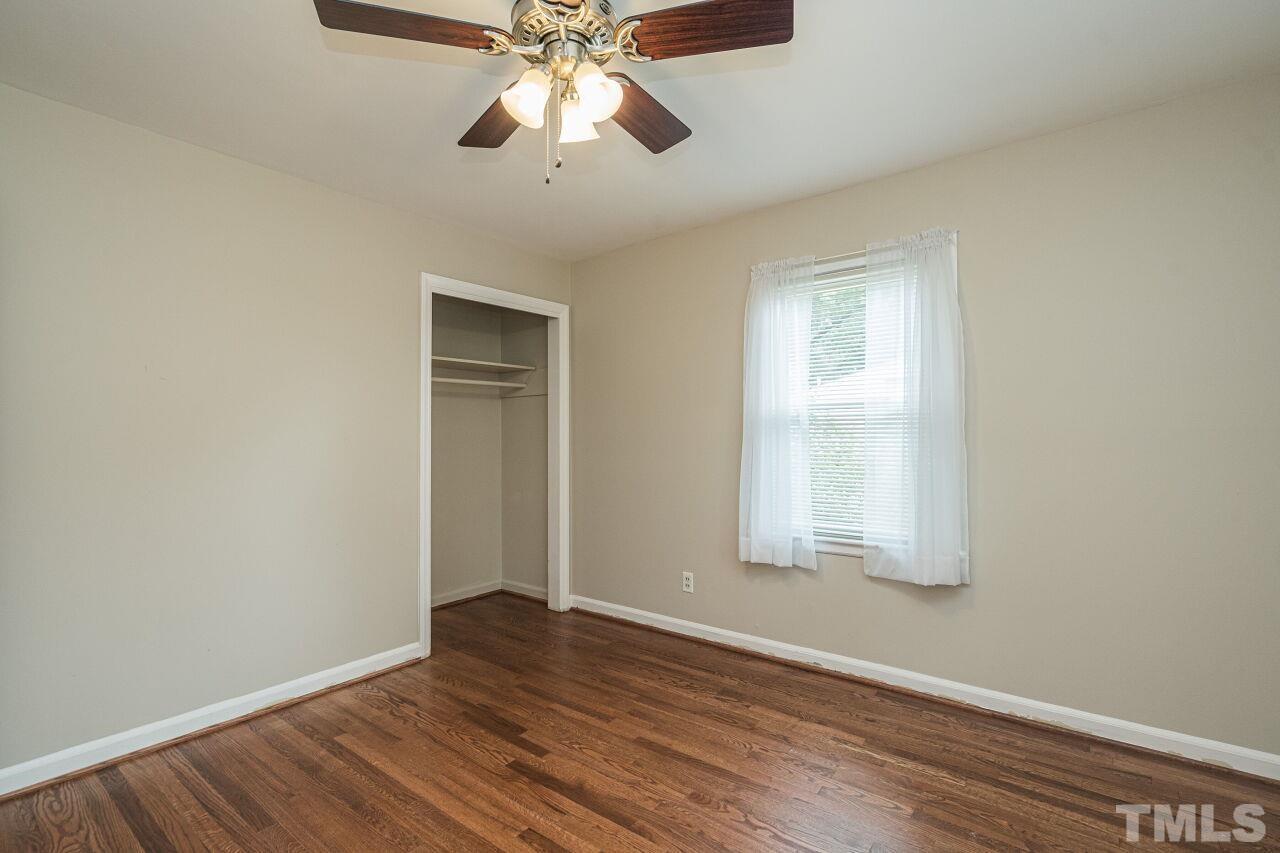 913 Culpepper Lane Raleigh, NC 27610 - Photo 18 of 23 an empty room with wooden floor closet and windows