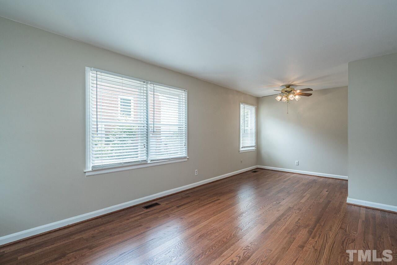 913 Culpepper Lane Raleigh, NC 27610 - Photo 3 of 23 an empty room with wooden floor and windows