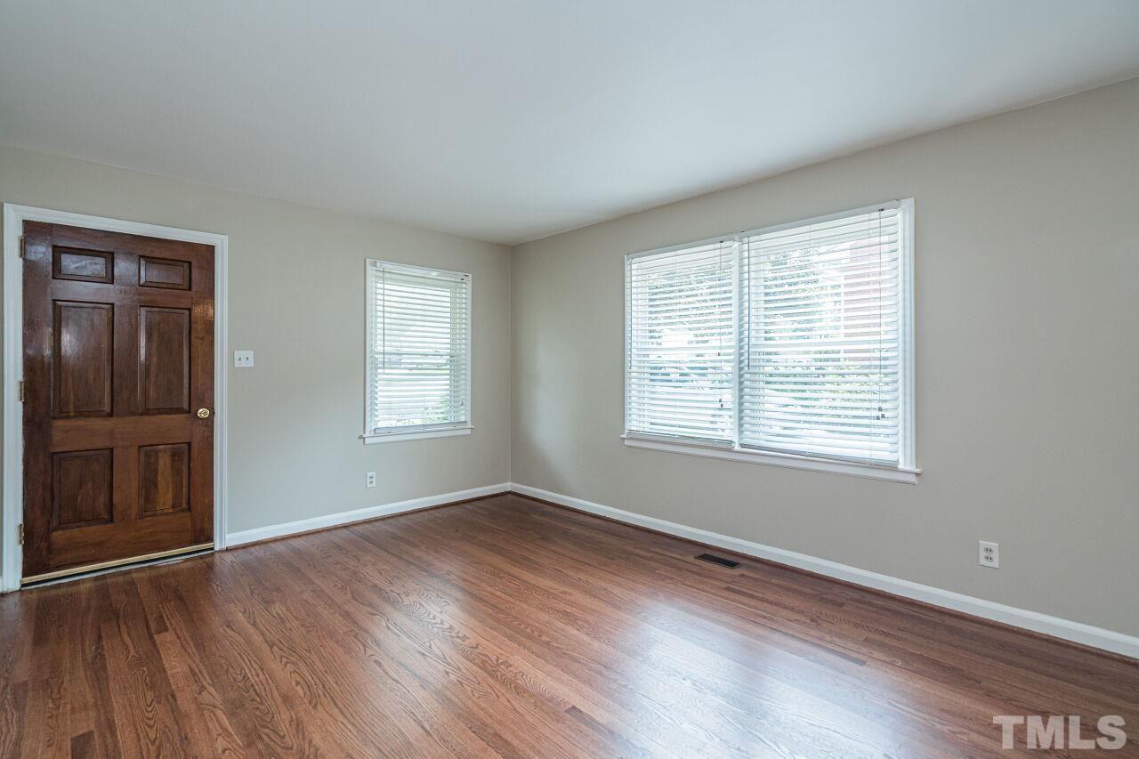 913 Culpepper Lane Raleigh, NC 27610 - Photo 4 of 23 a view of an empty room with wooden floor and a window