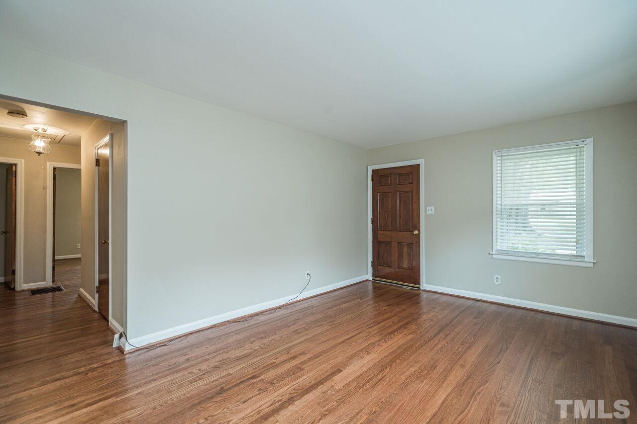 913 Culpepper Lane Raleigh, NC 27610 - Photo 5 of 23 an empty room with wooden floor and windows