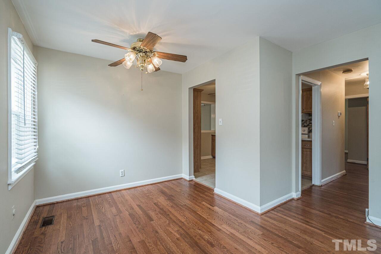 913 Culpepper Lane Raleigh, NC 27610 - Photo 6 of 23 an empty room with wooden floor closet and windows