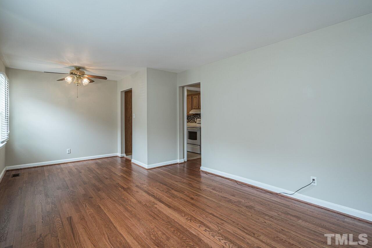 913 Culpepper Lane Raleigh, NC 27610 - Photo 7 of 23 a view of an empty room with wooden floor