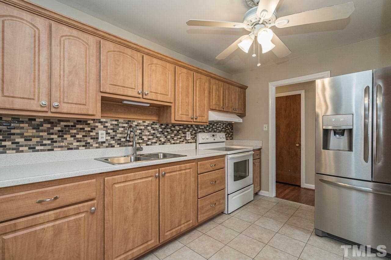 913 Culpepper Lane Raleigh, NC 27610 - Photo 9 of 23 a kitchen with stainless steel appliances granite countertop a refrigerator sink and cabinets