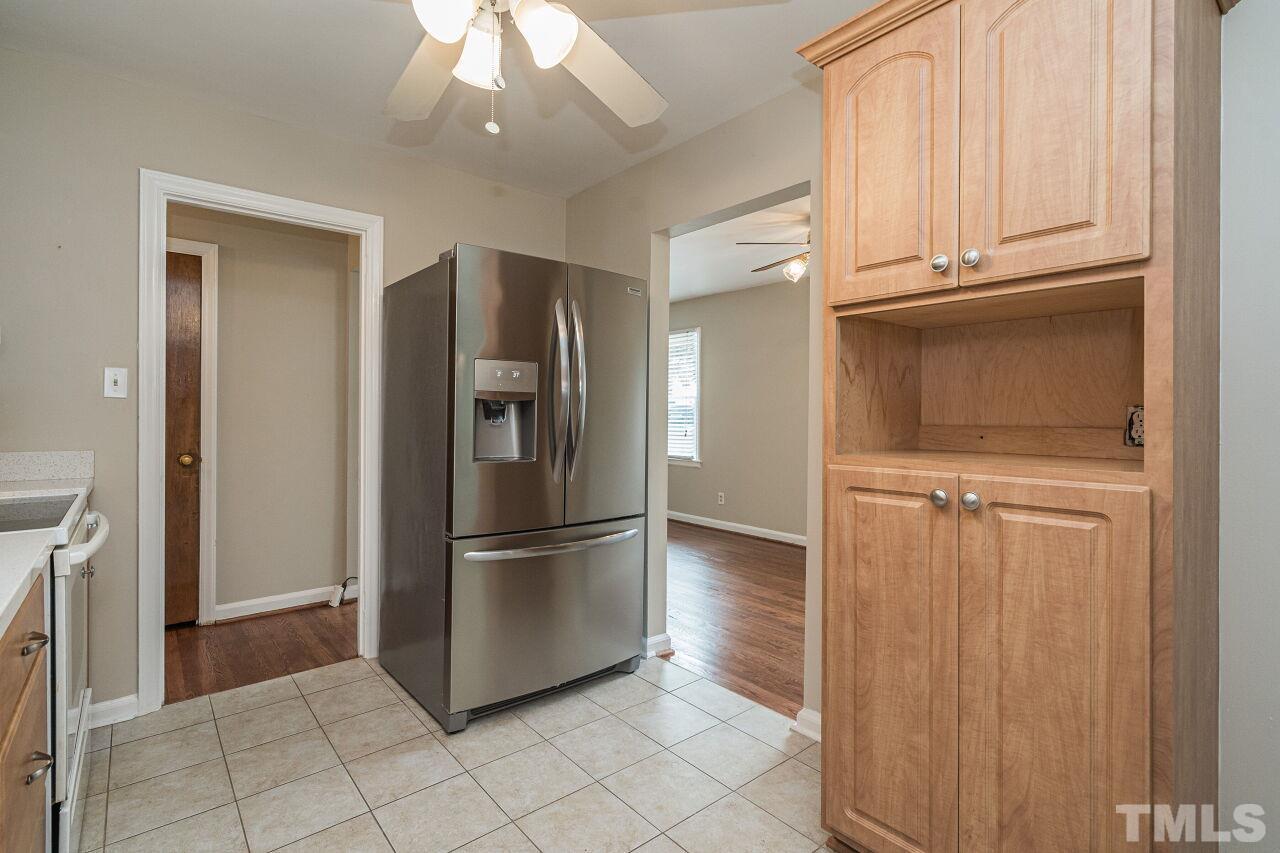 913 Culpepper Lane Raleigh, NC 27610 - Photo 10 of 23 a kitchen with granite countertop a refrigerator and a stove top oven