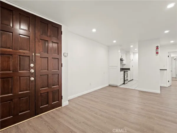 a view of an empty room with wooden floor