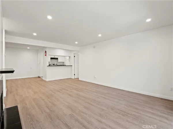 a view of a kitchen with a sink and a refrigerator