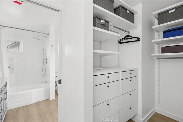 a bedroom with a bed and painting on the wall