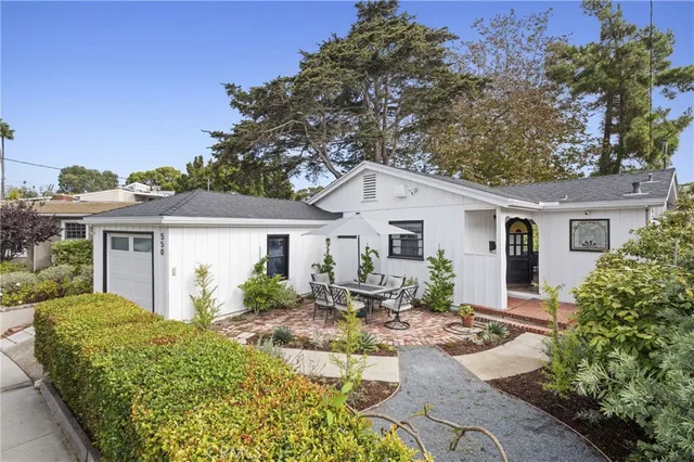 a view of a house with backyard sitting area and garden