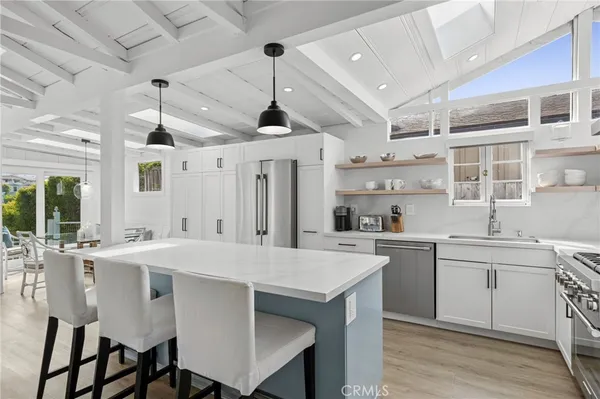a large kitchen with a table and chairs