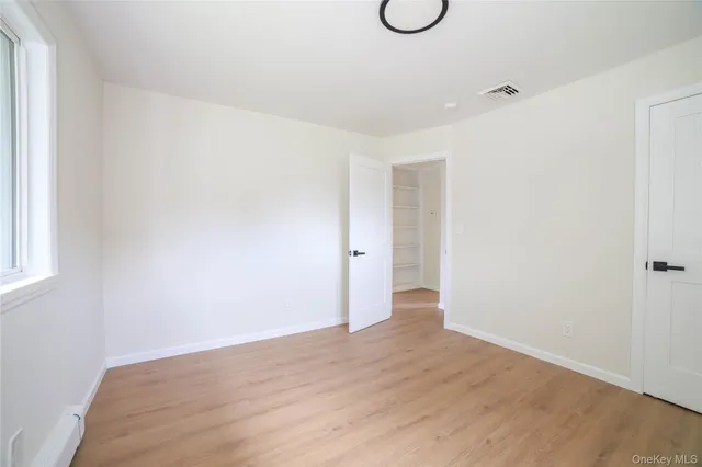 a view of a room with wooden floor and window