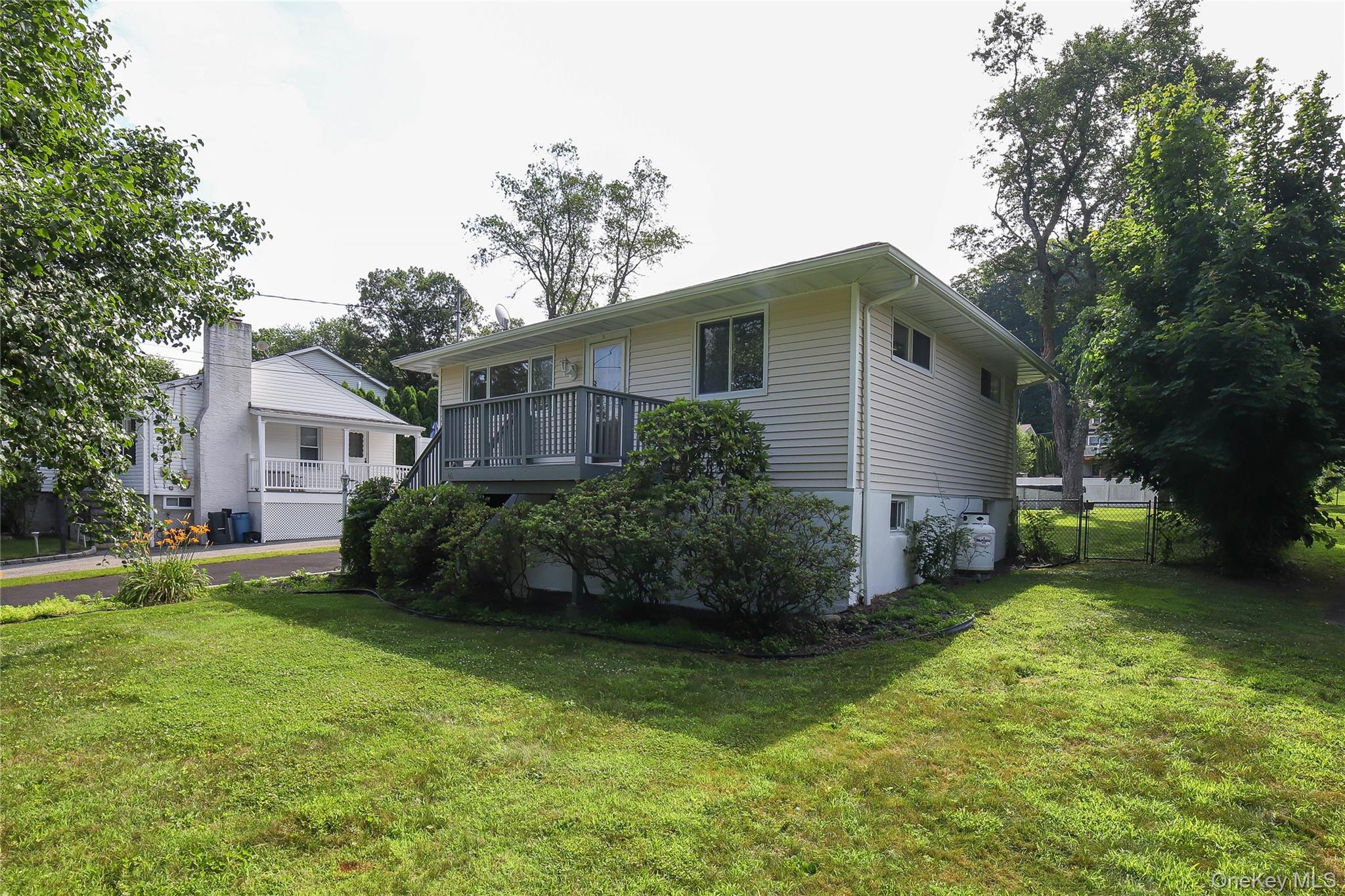 66 Putnam Road Cortlandt Manor, NY 10567 - Photo 2 of 37 a front view of house with yard and green space