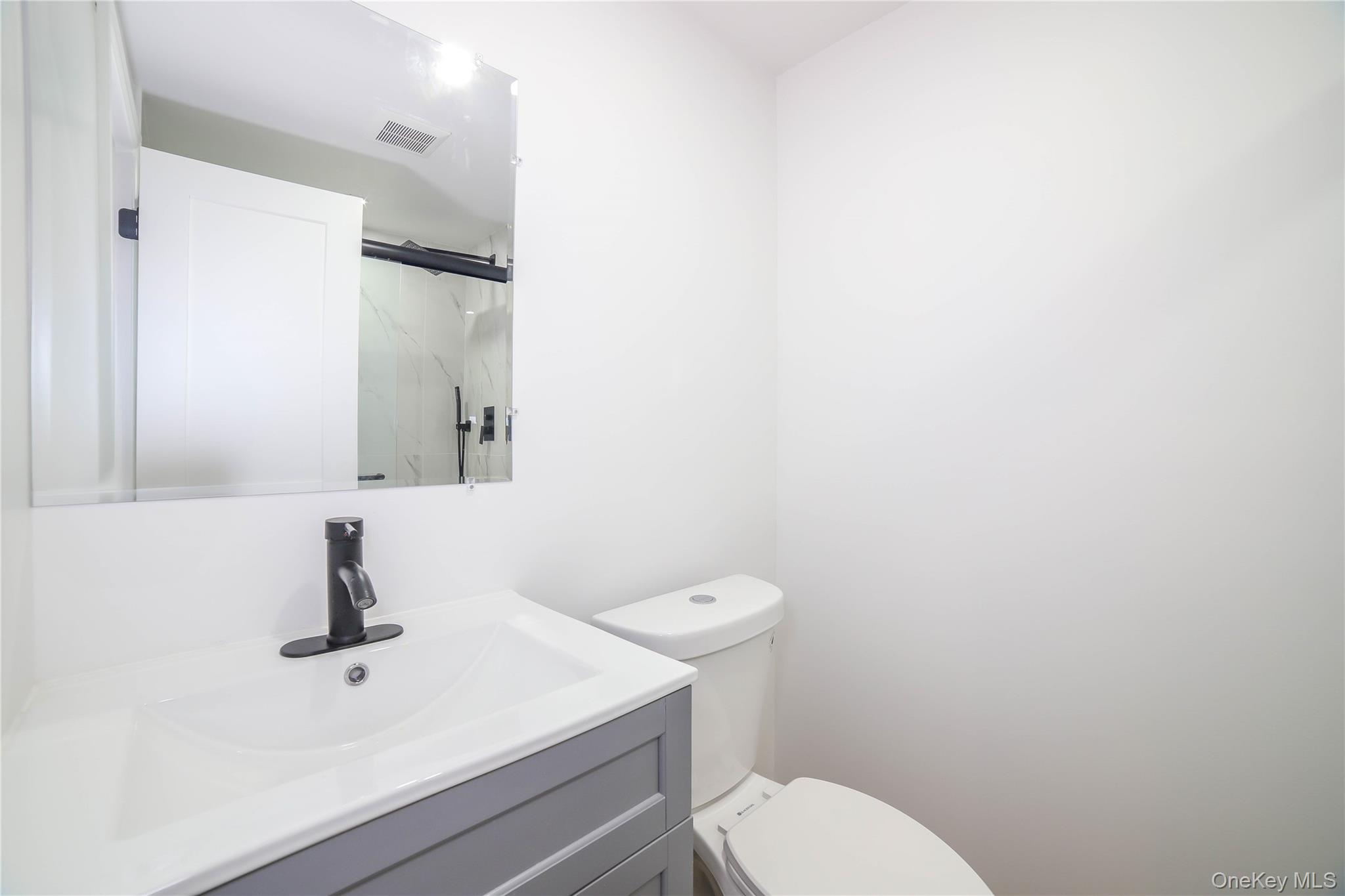 66 Putnam Road Cortlandt Manor, NY 10567 - Photo 22 of 37 a bathroom with a sink a toilet and mirror