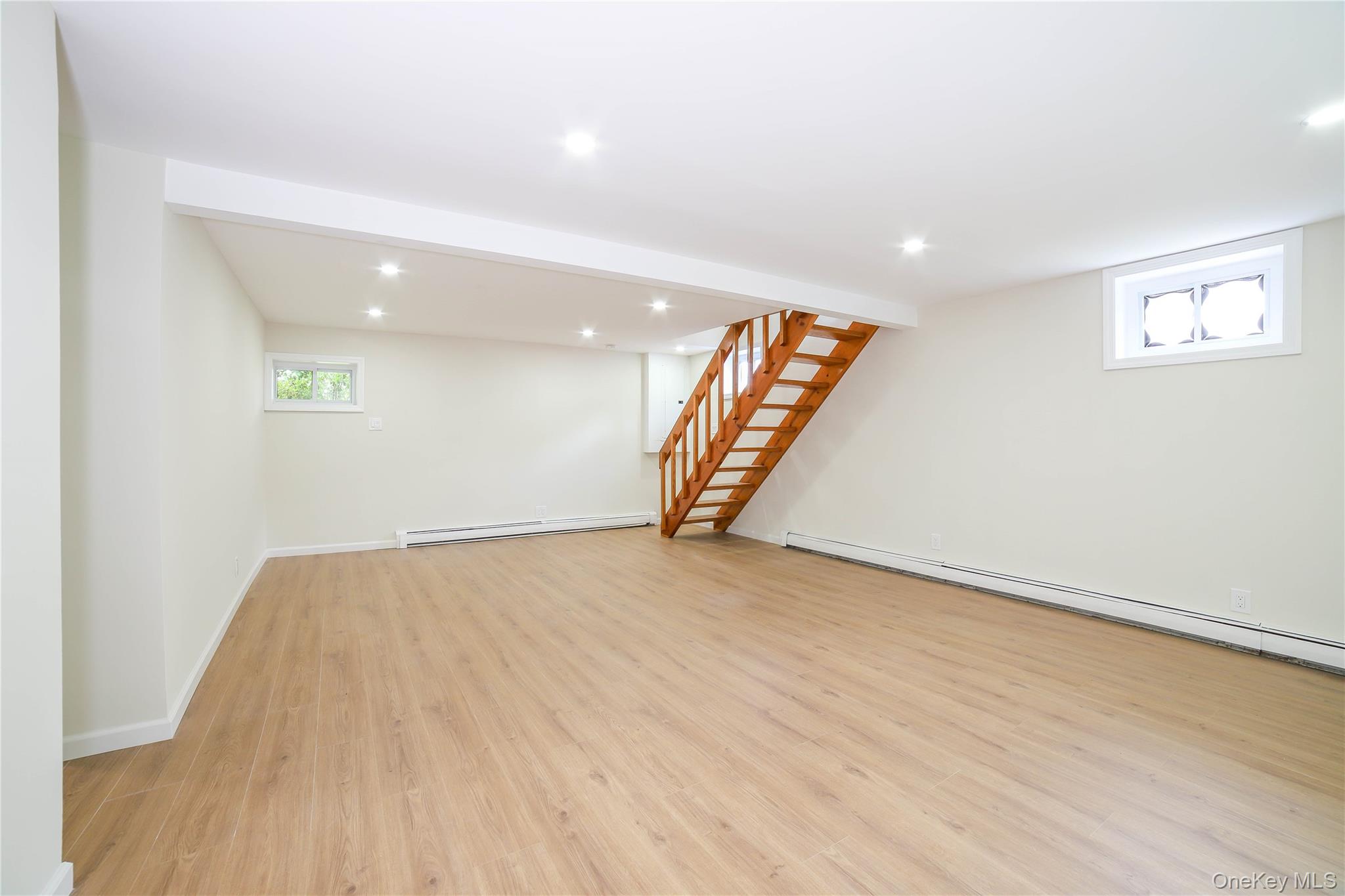 66 Putnam Road Cortlandt Manor, NY 10567 - Photo 24 of 37 an empty room with wooden floor and stairs