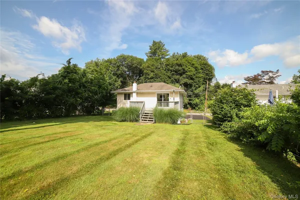 a view of a house with pool and a yard