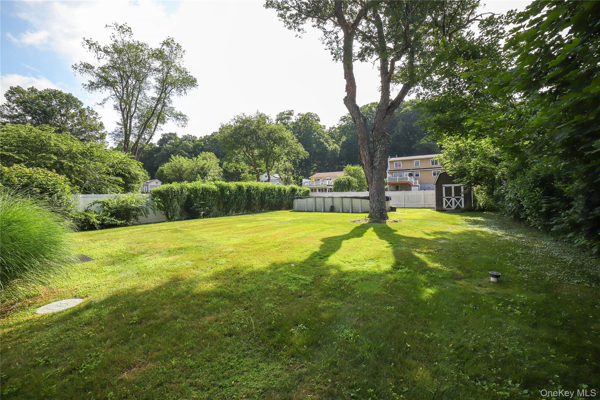 66 Putnam Road Cortlandt Manor, NY 10567 - Photo 30 of 37 a view of a garden with a bench