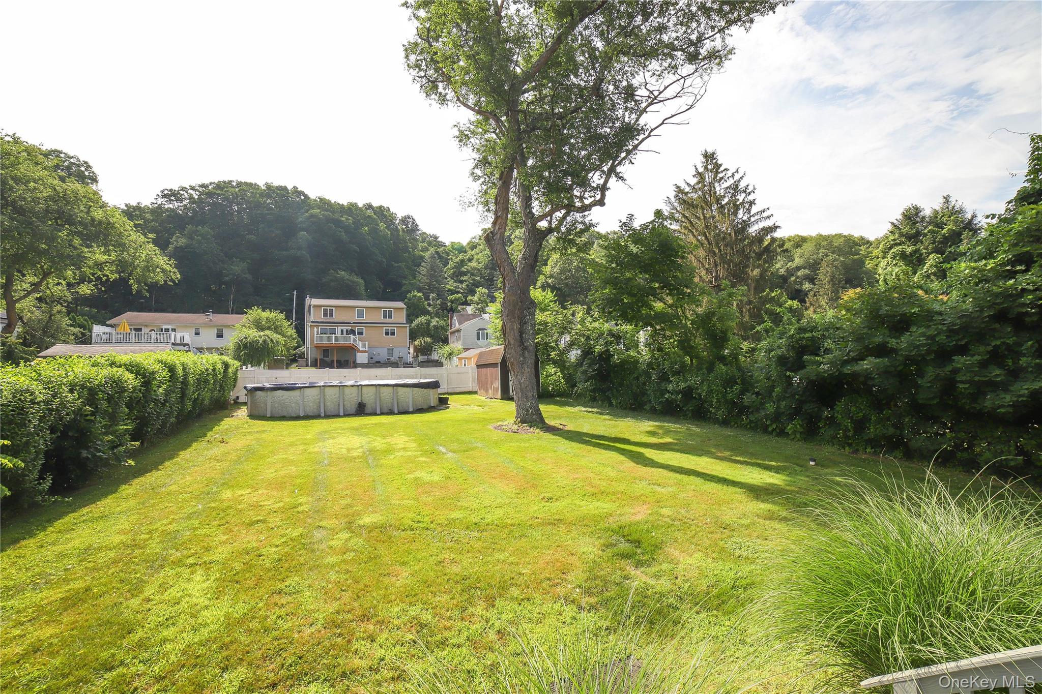 66 Putnam Road Cortlandt Manor, NY 10567 - Photo 31 of 37 a view of a swimming pool and a yard