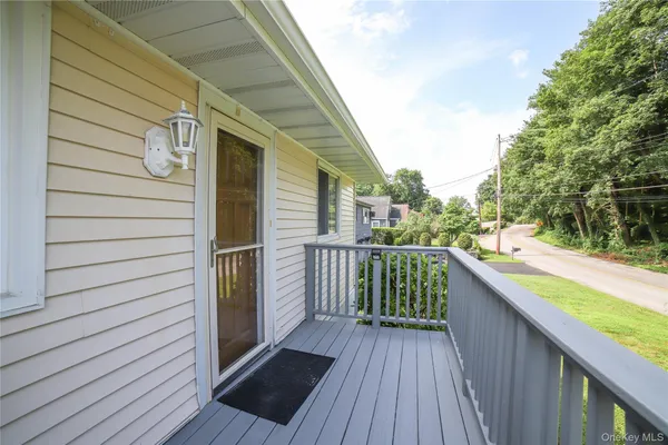a balcony with view of kitchen and wooden floor