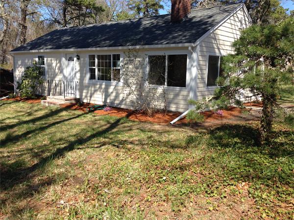 152 Telegraph Road Dennis, MA 02639 - Photo 1 of 11 a backyard of a house with barbeque oven table and chairs