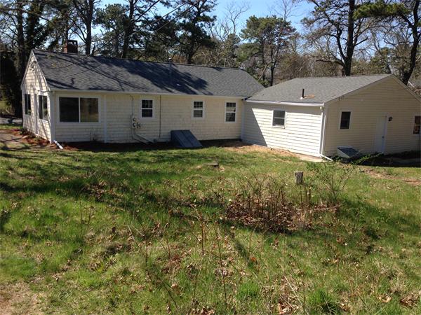 152 Telegraph Road Dennis, MA 02639 - Photo 3 of 11 a view of a backyard with large trees