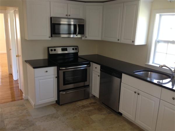 152 Telegraph Road Dennis, MA 02639 - Photo 4 of 11 a kitchen with stainless steel appliances a stove a microwave and cabinets
