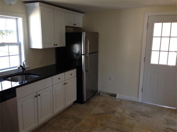 152 Telegraph Road Dennis, MA 02639 - Photo 5 of 11 a kitchen with granite countertop white cabinets and refrigerator