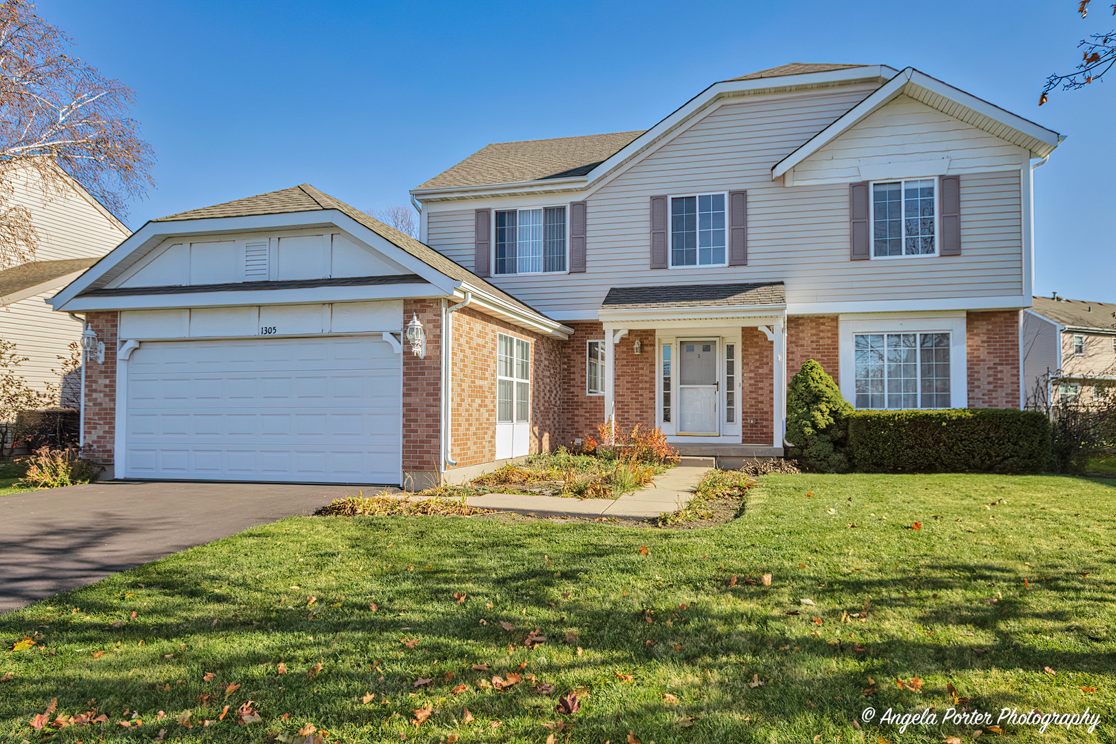 1305 Westport Ridge Crystal Lake, IL 60014 - Photo 1 of 31 a front view of a house with a yard and garage