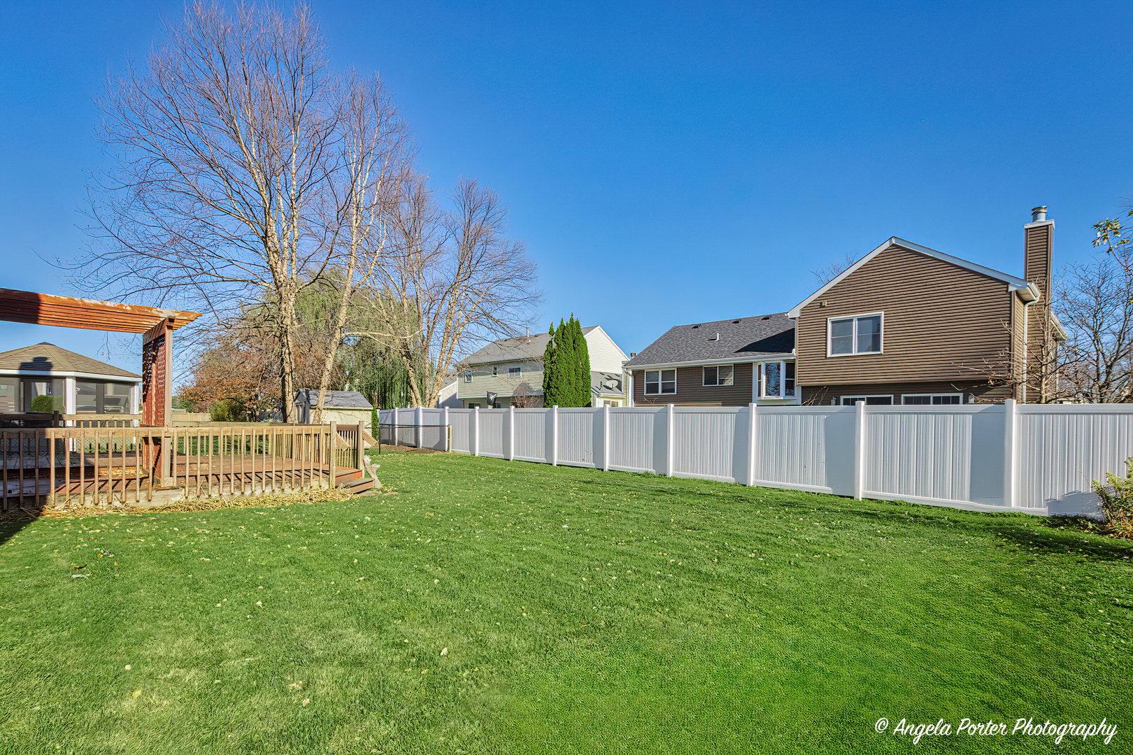 1305 Westport Ridge Crystal Lake, IL 60014 - Photo 27 of 31 a view of a house with a yard and a wooden fence