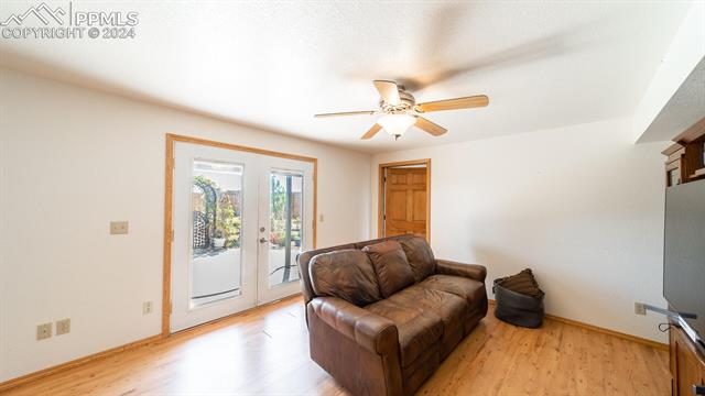 11125 Eureka Road Calhan, CO 80808 - Photo 33 of 44 Living area featuring ceiling fan, light hardwood / wood-style floors, and french doors
