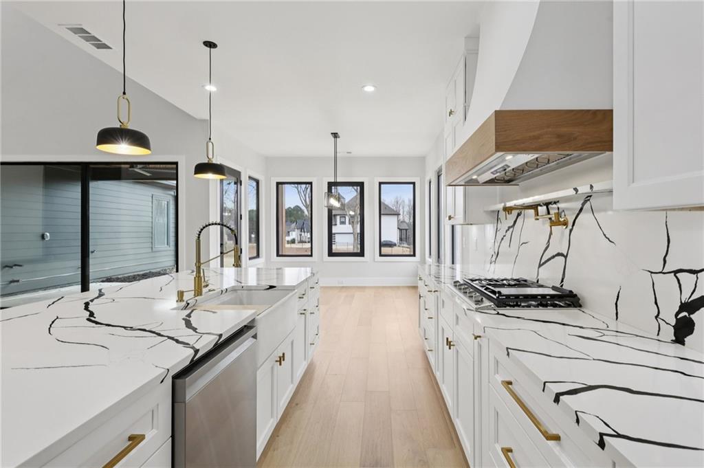 24 Rocking Wood Drive Auburn, GA 30011 - Photo 25 of 66 a kitchen with stainless steel appliances a sink a stove a refrigerator and cabinets